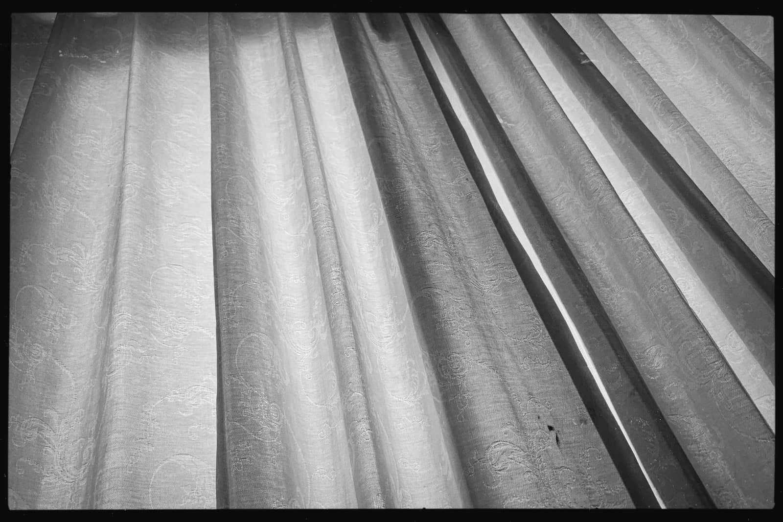 Layered white curtain fabric showing a lining behind the face panel