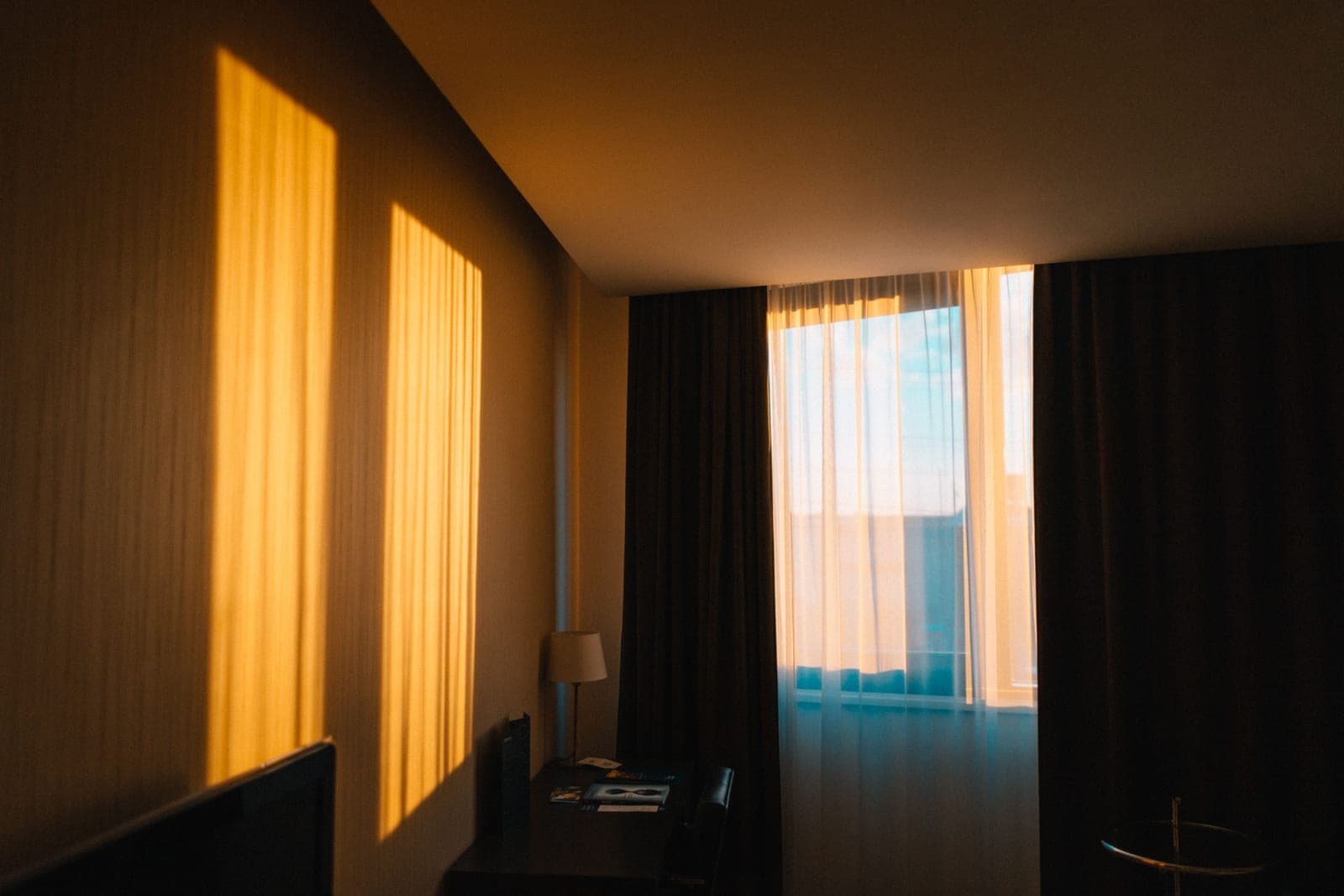 Sunrise light striking the wall beside a bedroom window