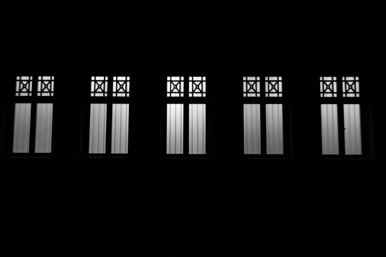 Daylight leaking around the edge of a covered window in a dark room