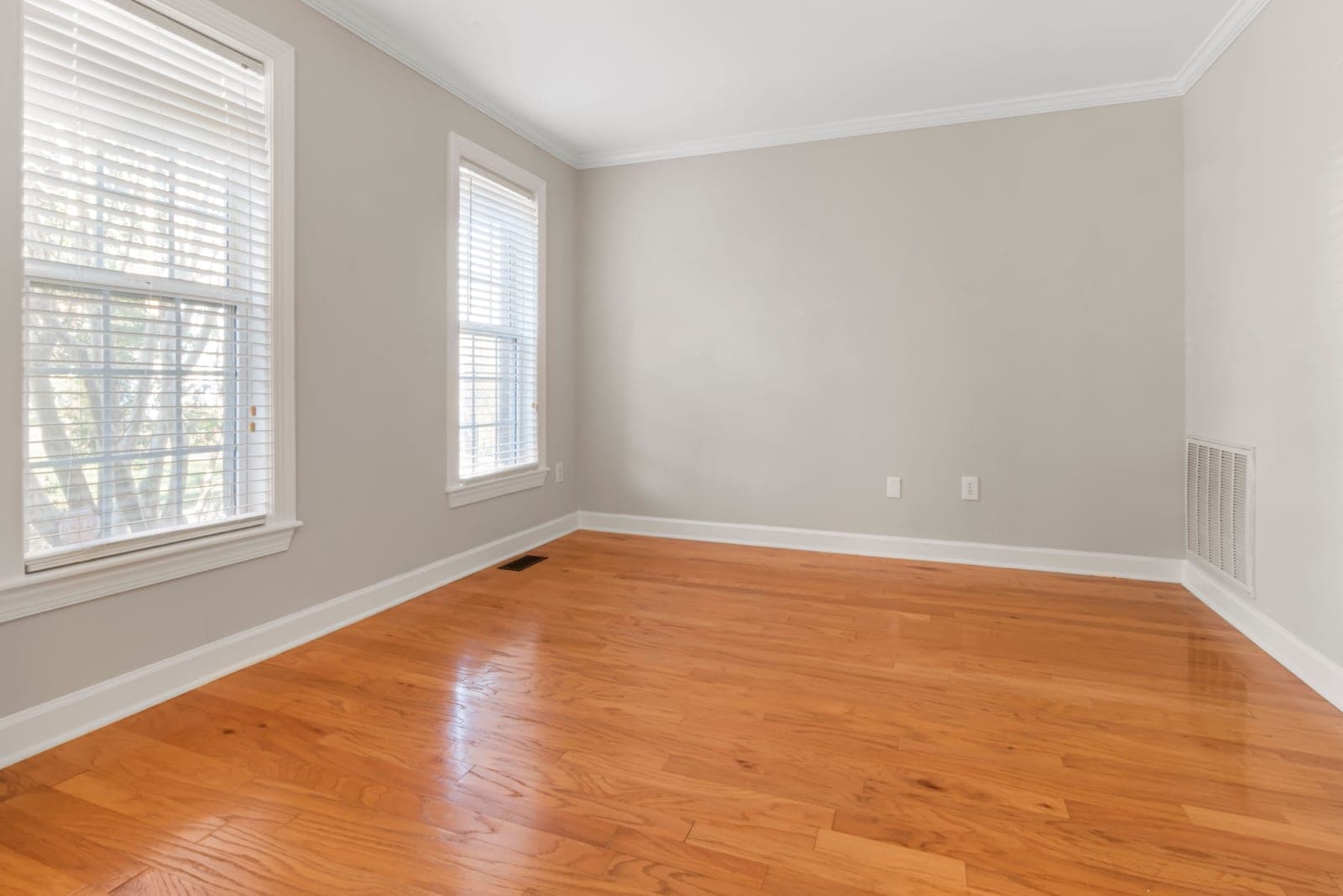 Wooden blinds in a bright room with daylight through the slats