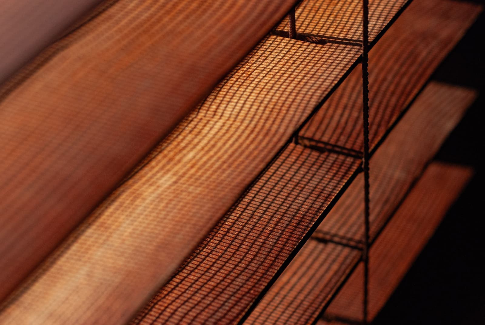 An interior with both slatted blinds and fabric shades on adjacent windows