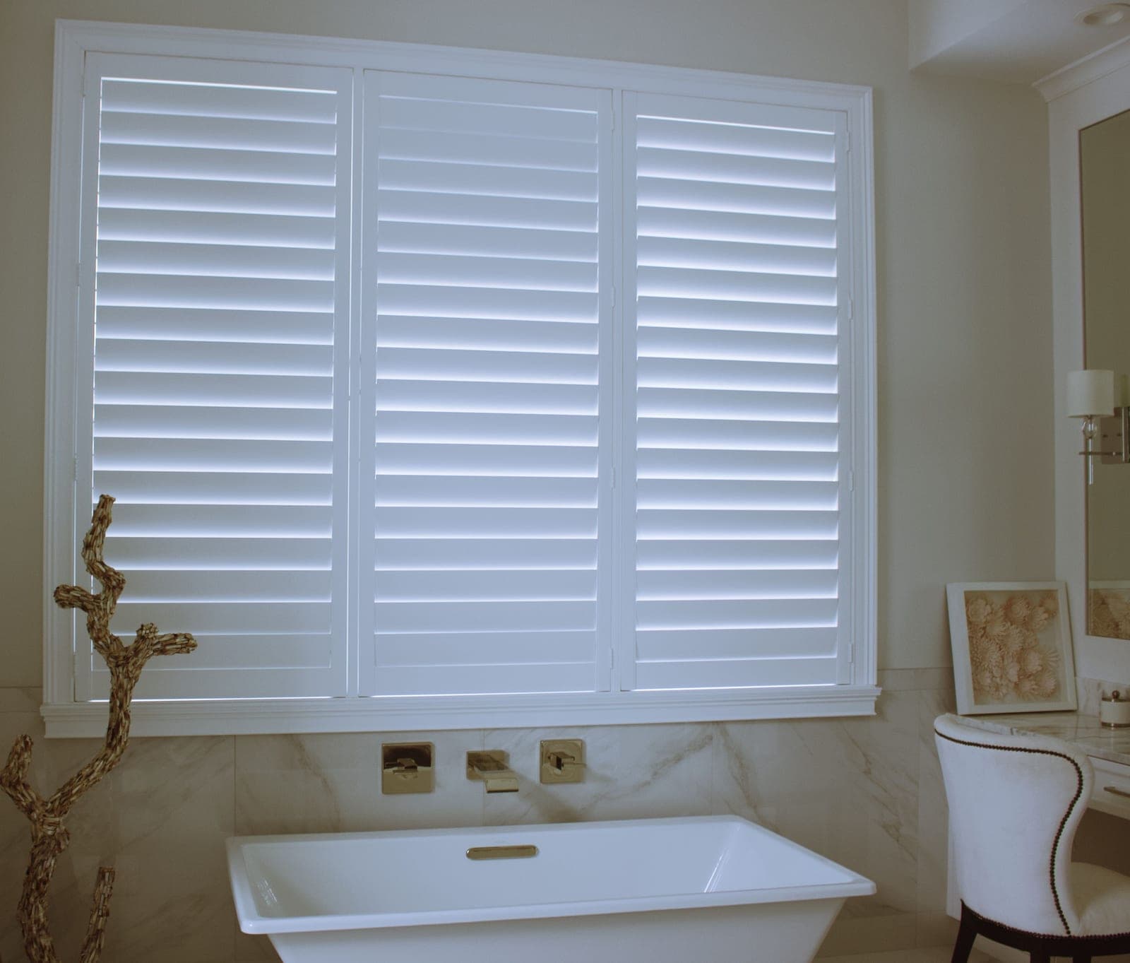 White plantation shutters fitted to an interior window