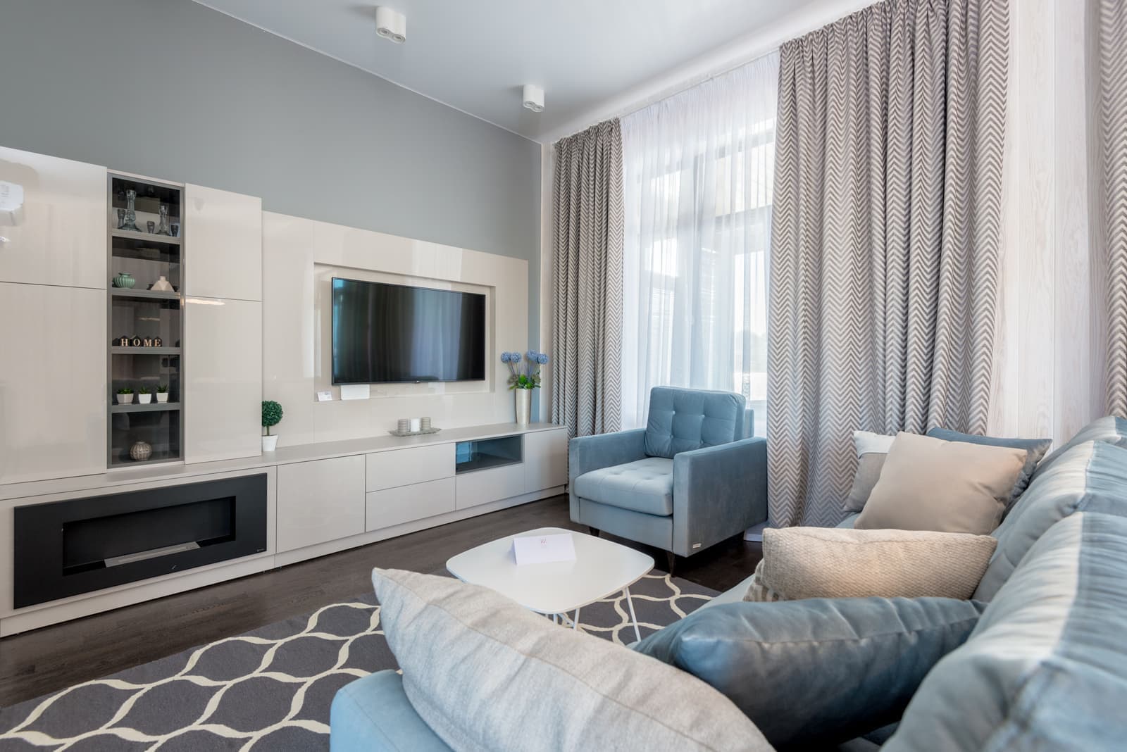 A living room television beside a window with strong daylight