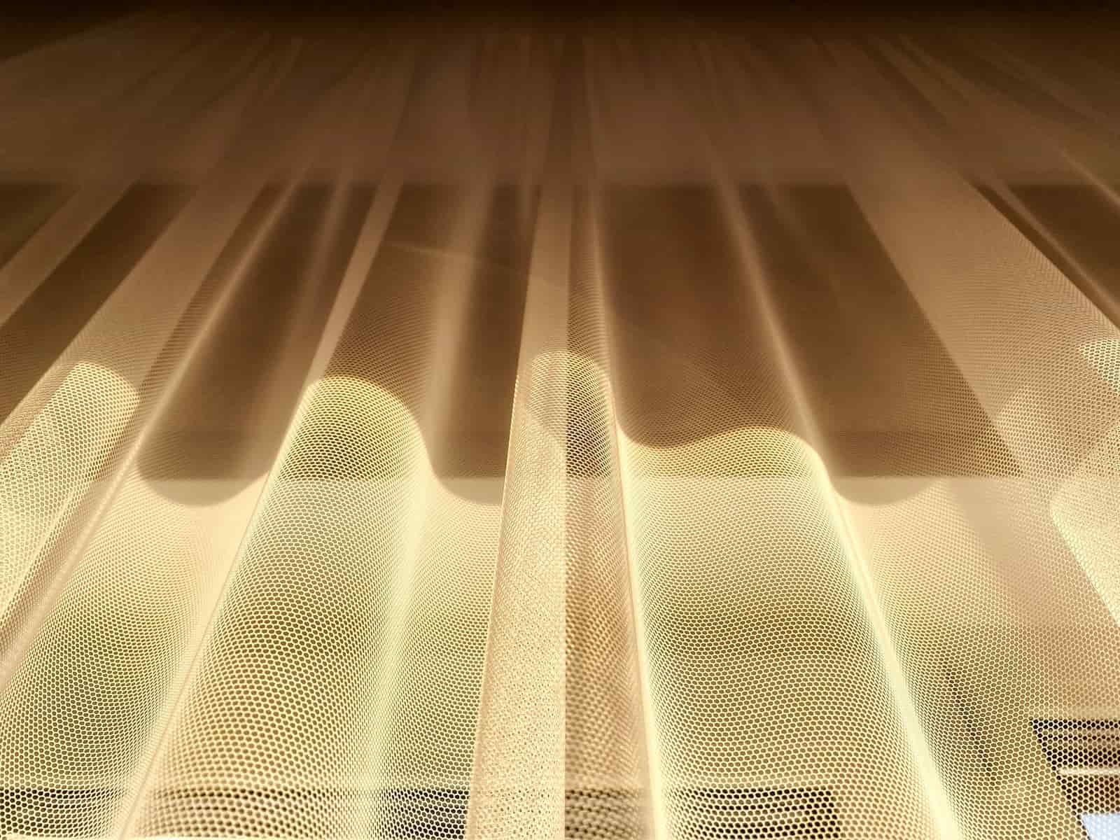 White sheer curtains diffusing sunlight across a bright room