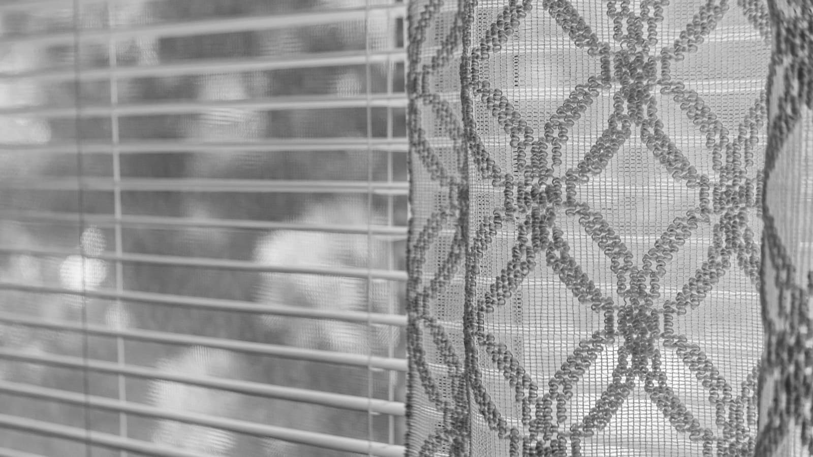 Soft light passing through a woven curtain fabric