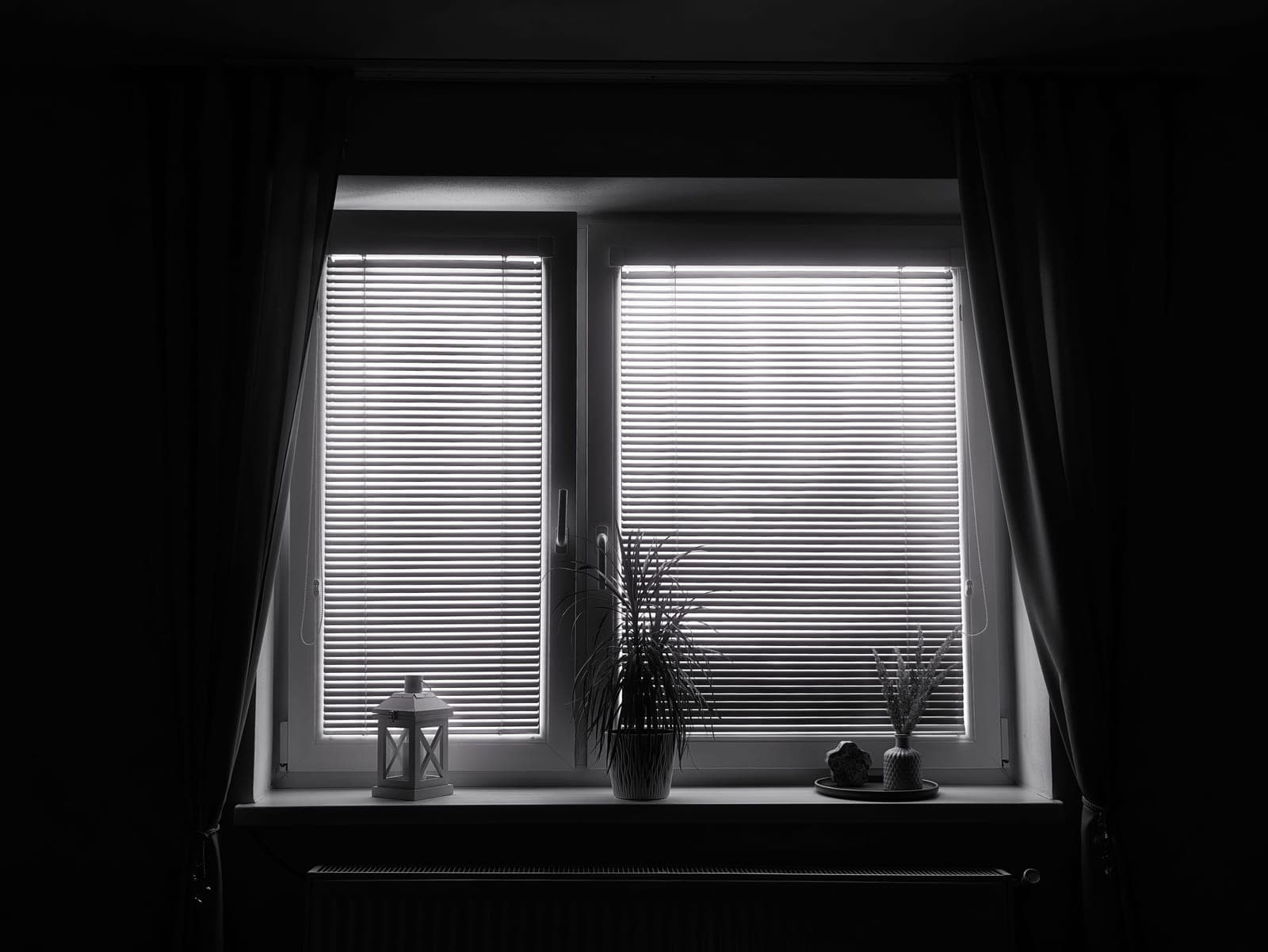 An interior showing blinds, shades and curtains on adjacent windows