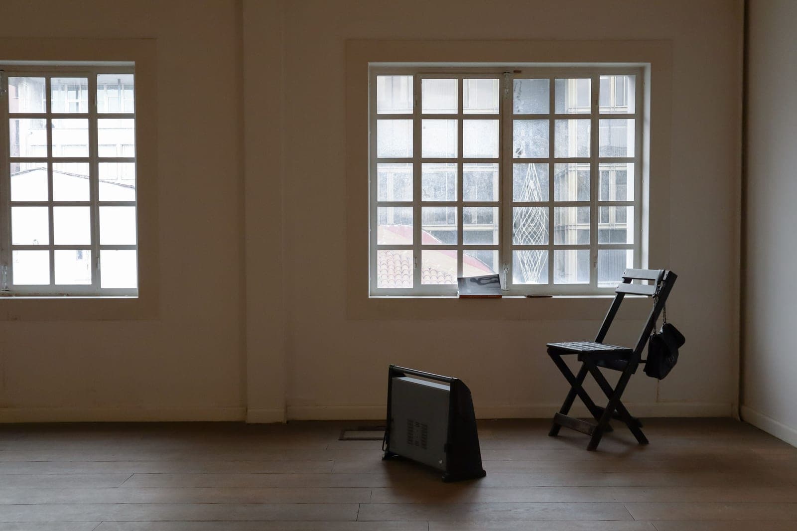 A series of calm, neutral interiors with daylight coming through the windows