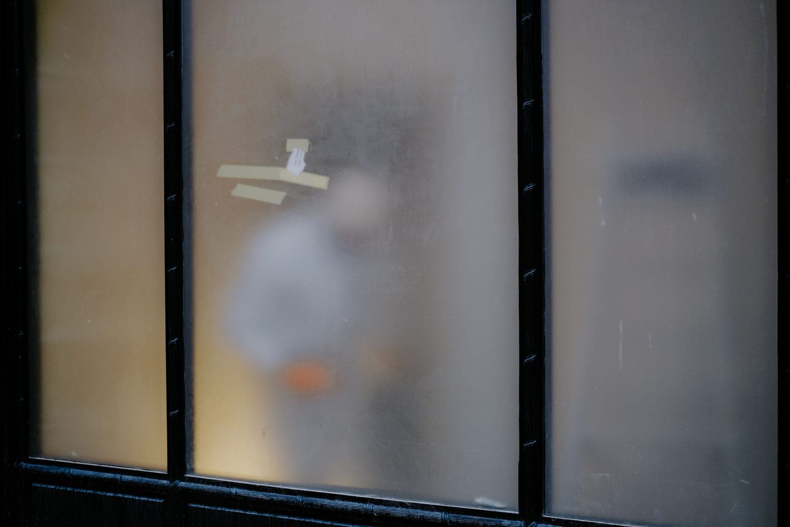 A bathroom window with obscured glass and natural light