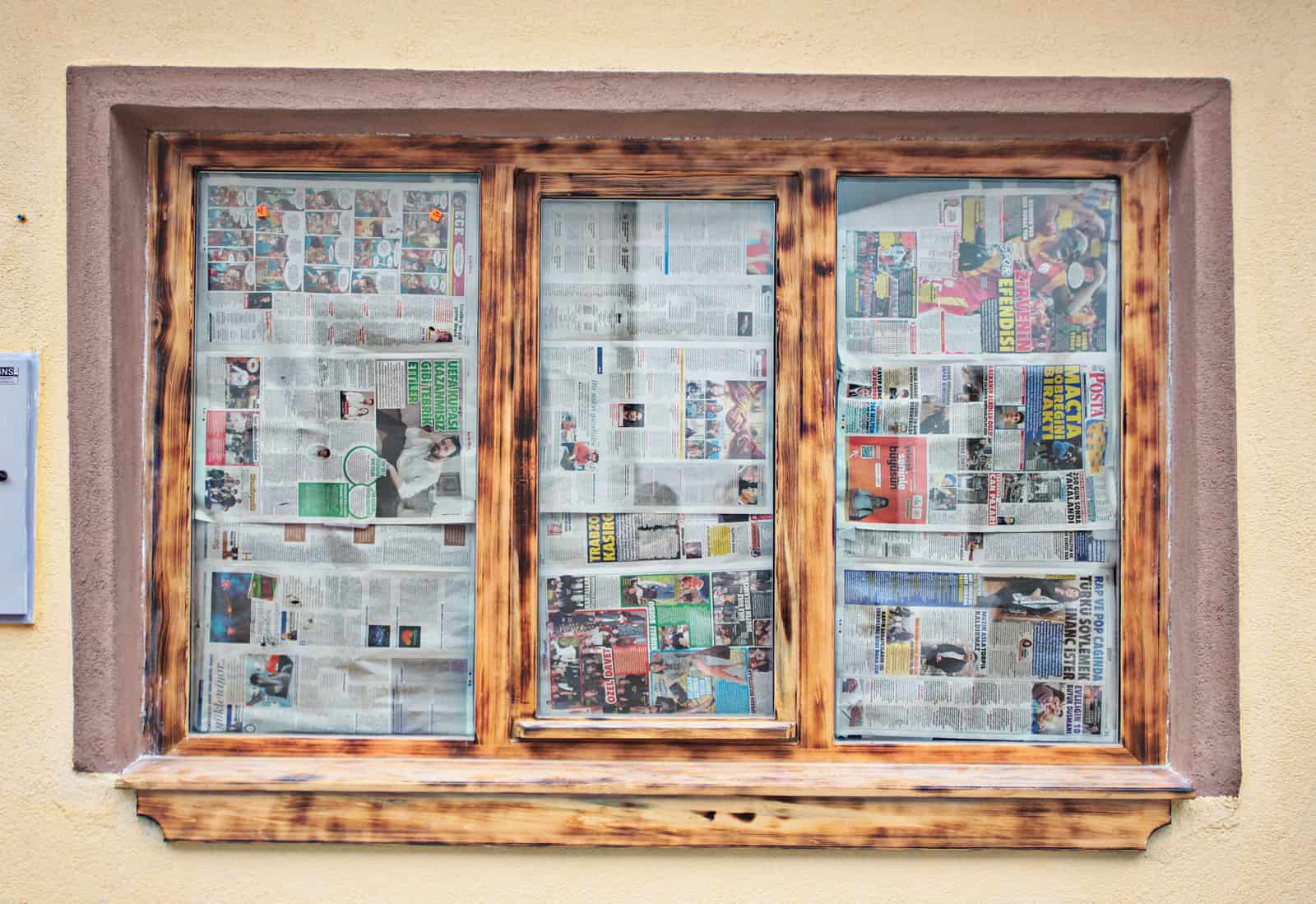 A temporary paper shade fitted in an apartment window