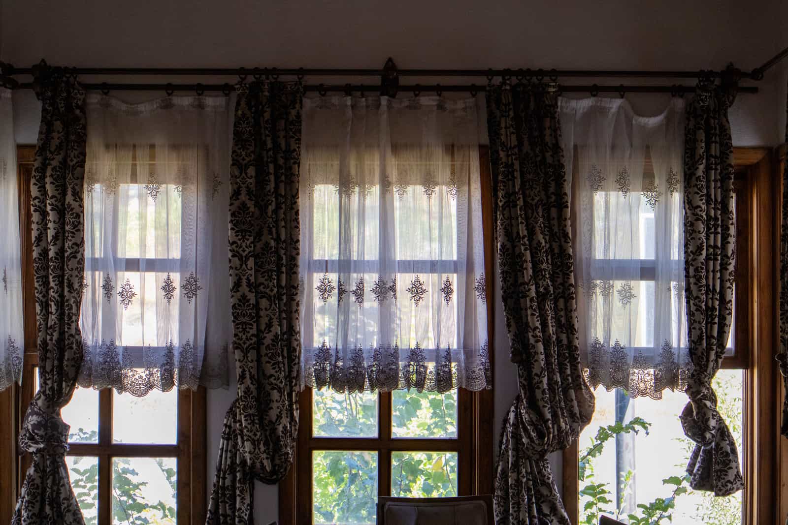 A curtain rod mounted above an apartment window without wall fixings