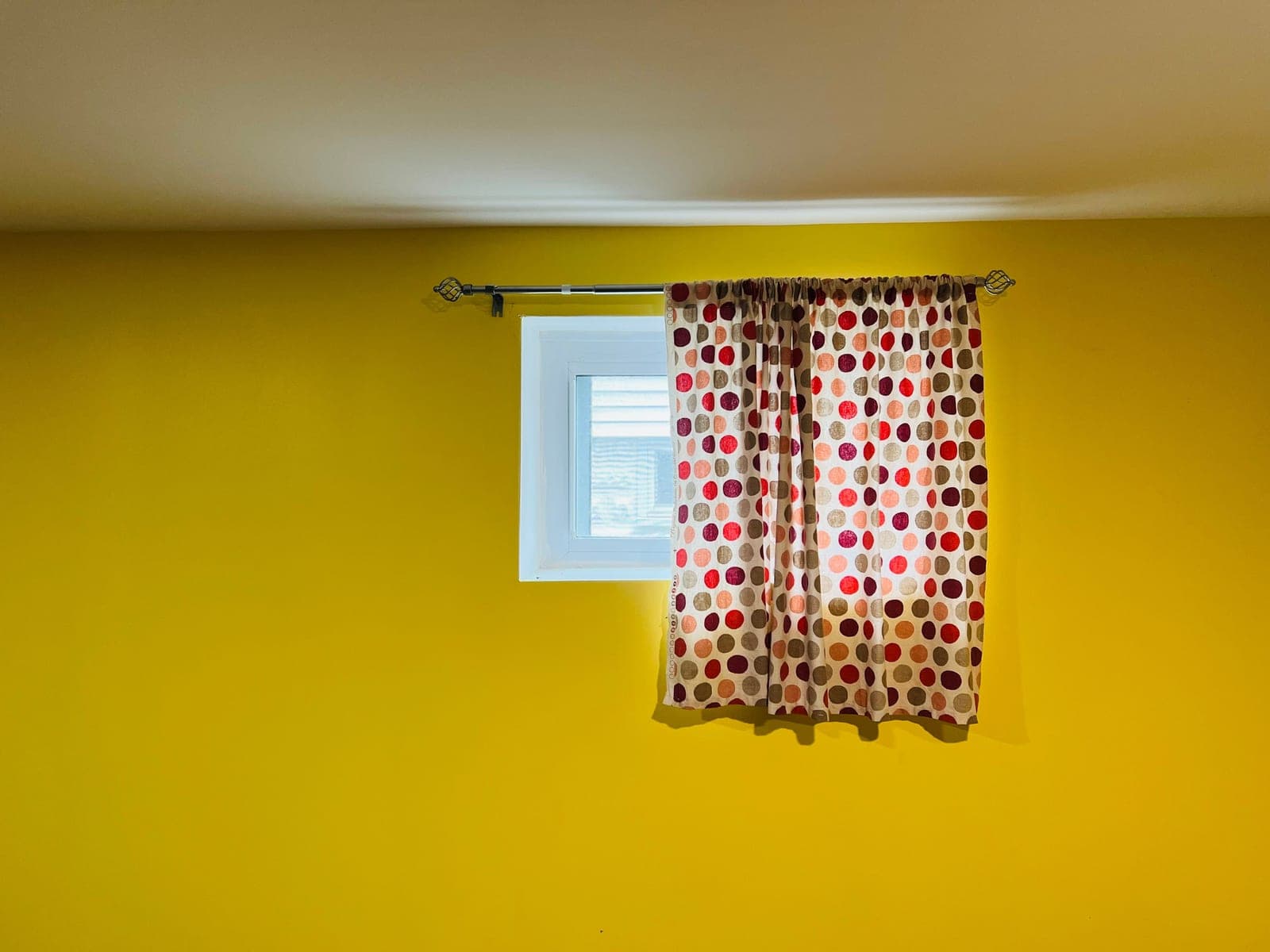 A tension rod fitted inside a window recess