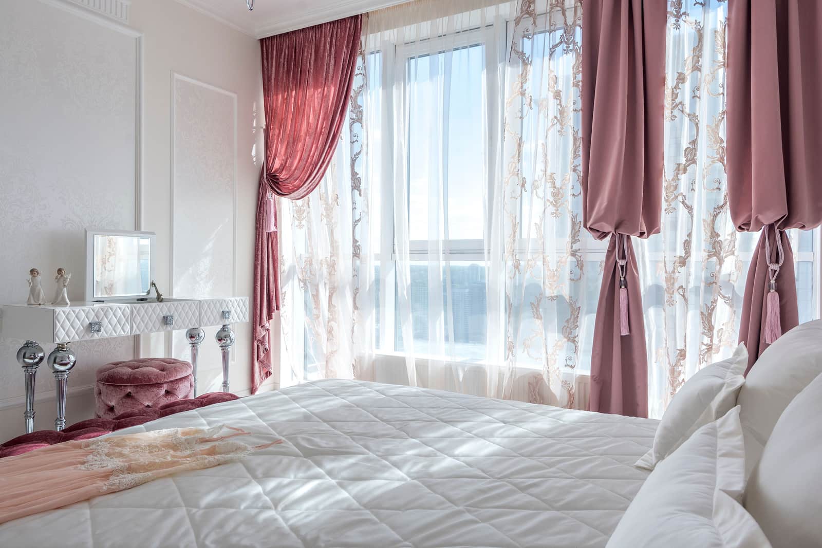 Heavy velvet drapes hanging from a substantial metal rod