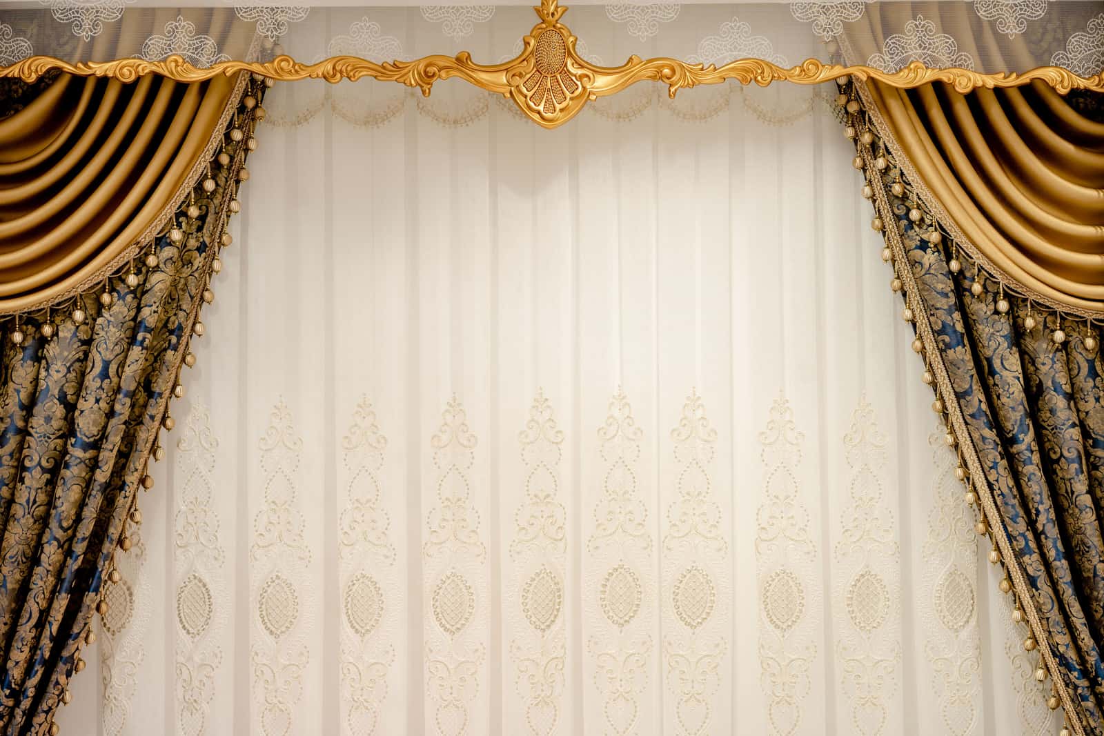 A decorative curtain rod with a finial above a window