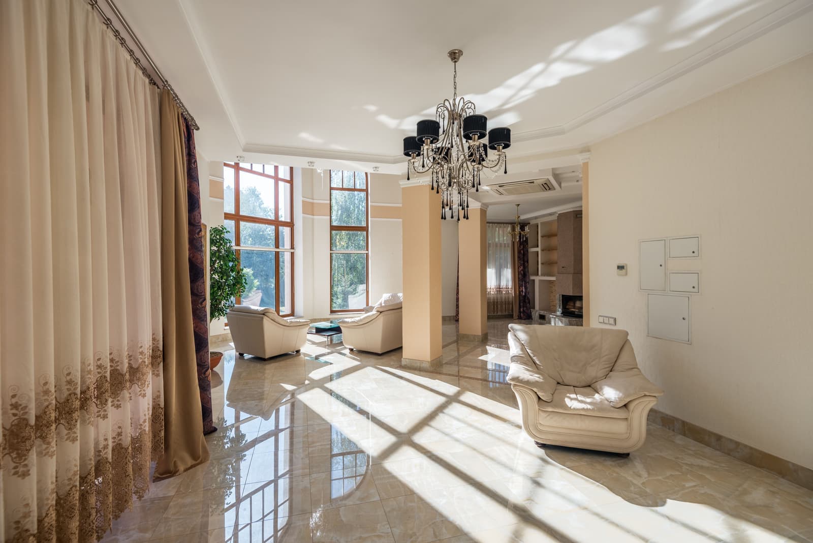 Tall curtains hung near the ceiling above a window